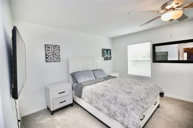 a bedroom with furniture and a flat screen tv