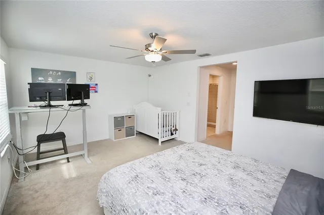 a bathroom with a granite countertop sink a toilet a mirror and shower curtain