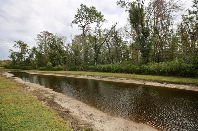 a view of house with swimming pool and lake view