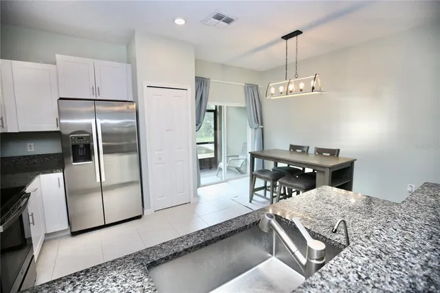 a living room with furniture kitchen view and a dining table