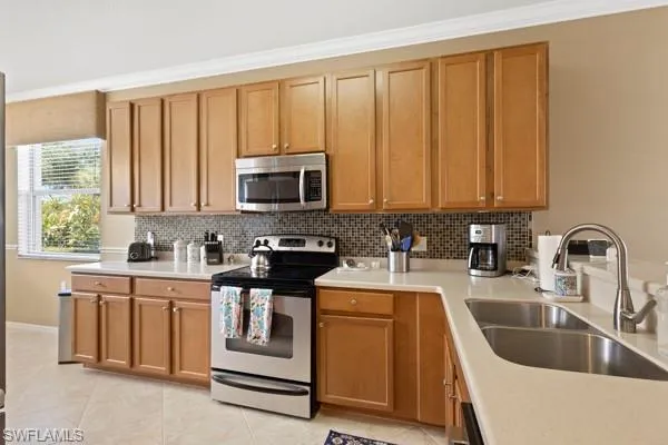 a kitchen with appliances a sink and cabinets