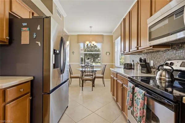 a kitchen with stainless steel appliances granite countertop a refrigerator and a stove top oven