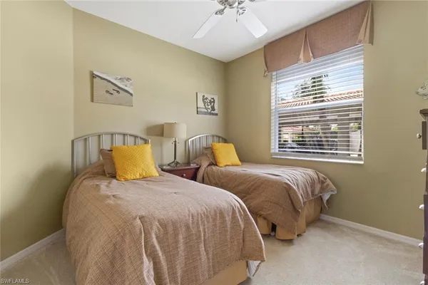 a bedroom with two beds and a chandelier