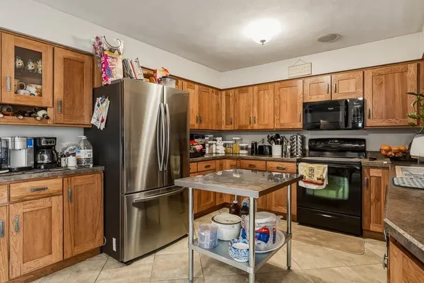 a kitchen with stainless steel appliances granite countertop a refrigerator stove and sink