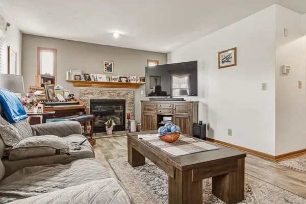 a living room with furniture a fireplace and a flat screen tv