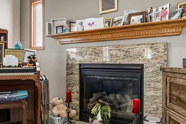 a living room with a fireplace furniture and a flat screen tv