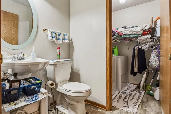 a bathroom with a toilet a sink and a mirror