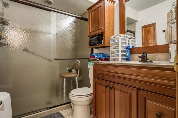 a bathroom with a toilet a sink and a mirror