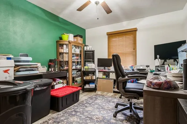 a view of a workspace with furniture and a window