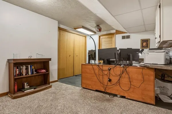 a living room with furniture a flat screen tv and a window