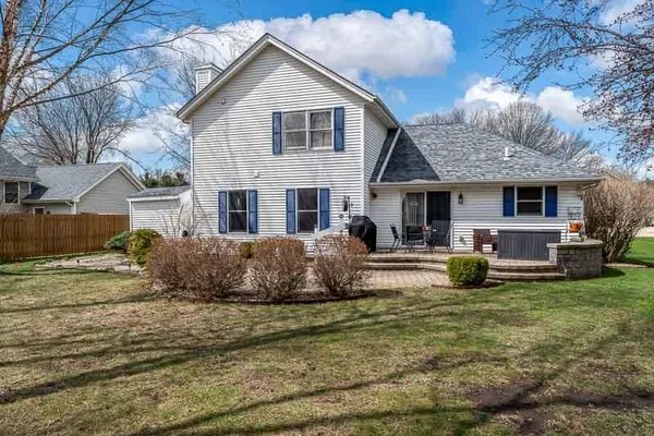 a front view of a house with a garden and plants