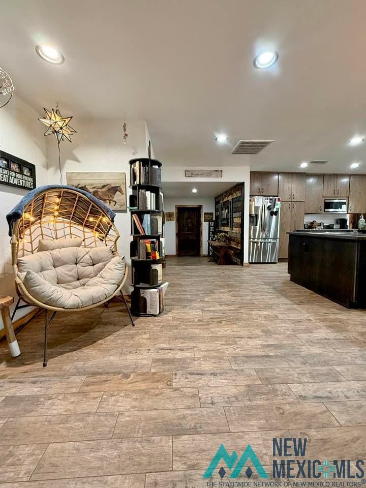 5404 Sioux Road Carlsbad, NM 88220 - Photo 13 of 100 Expansive open-concept room featuring wood-finish flooring throughout