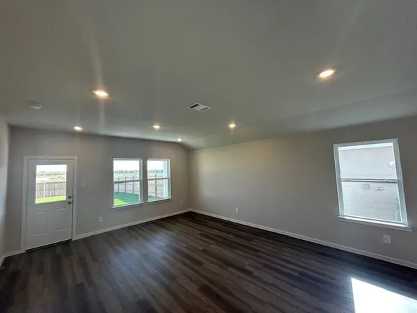 a kitchen with stainless steel appliances kitchen island granite countertop a stove a sink and a refrigerator