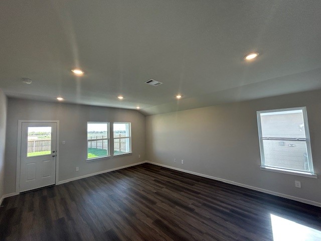 214 Perry Place Rockdale, TX 76567 - Photo 5 of 8 an empty room with wooden floor and windows