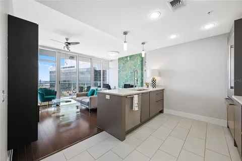 a room with a large window and furniture
