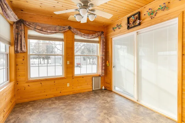 a large kitchen with stainless steel appliances a large window and a refrigerator