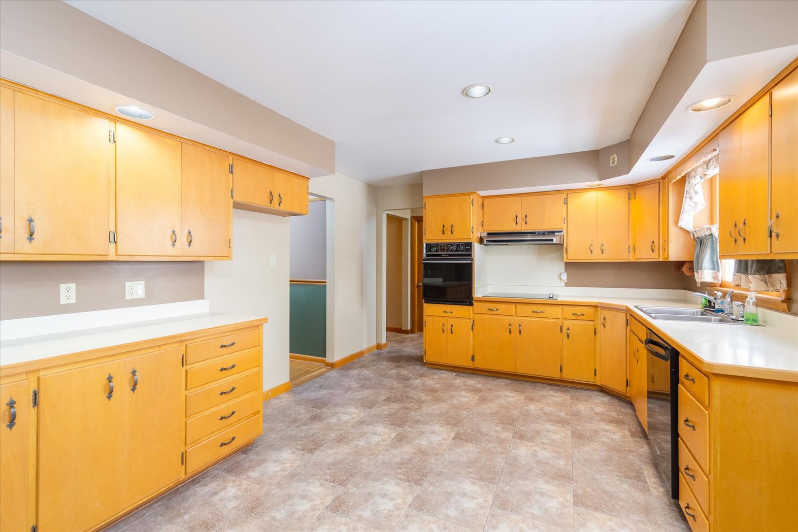 708 East Thompson Street Princeton, IL 61356 - Photo 15 of 40 a large kitchen with stainless steel appliances a large window and a refrigerator