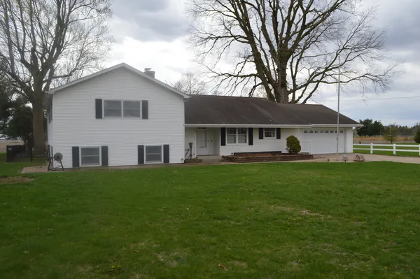 a front view of house with yard and green space