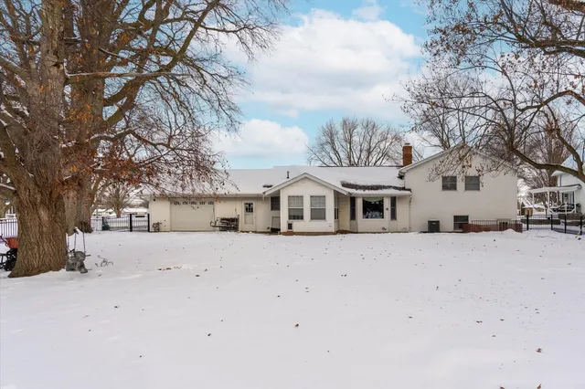 a view of a house with snow on the road