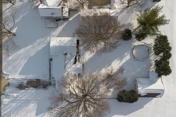 a view of a house with snow on the road