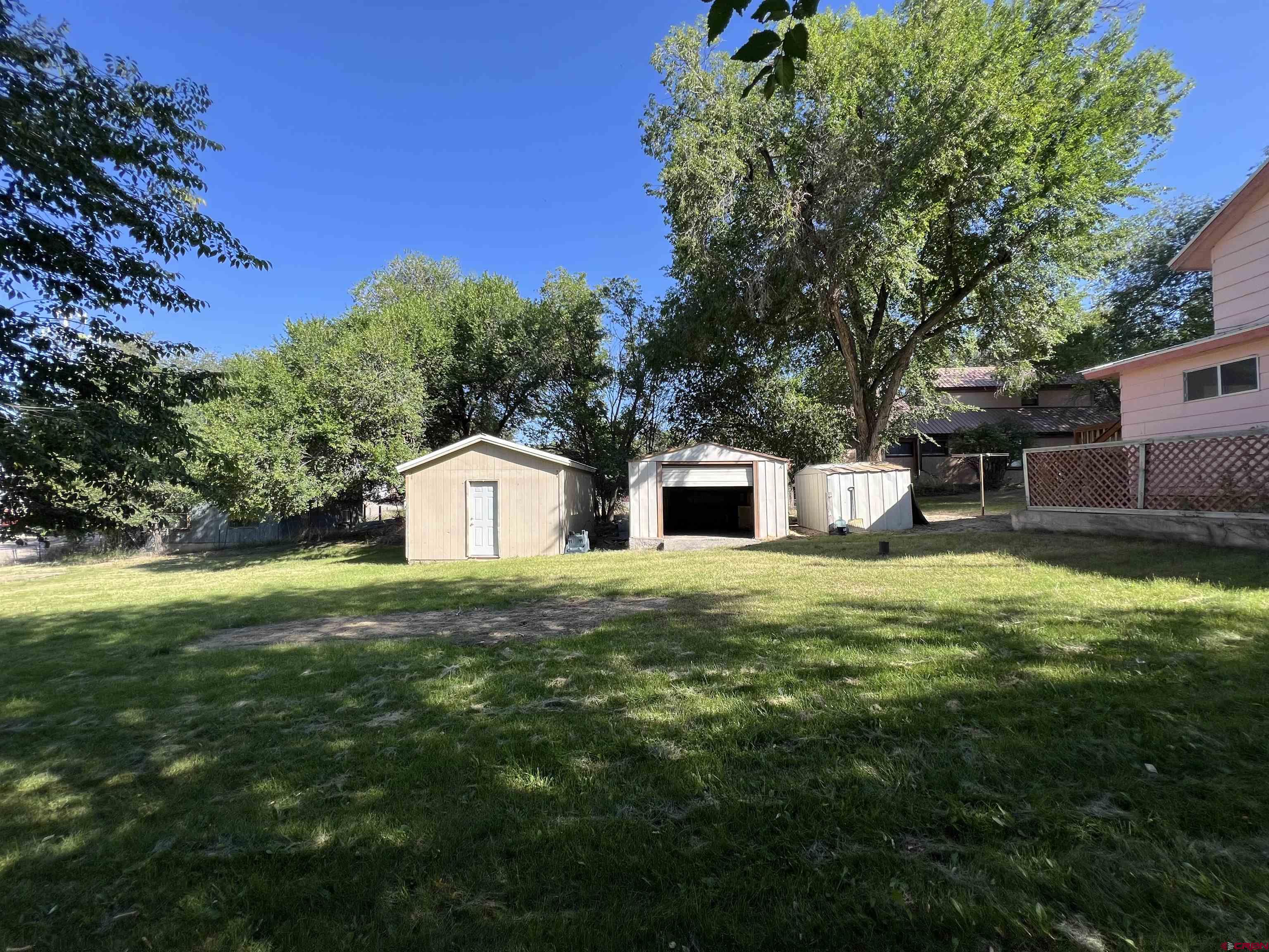 460 Fox Street Nucla, CO 81424 - Photo 12 of 35 a front view of a house with a garden and trees