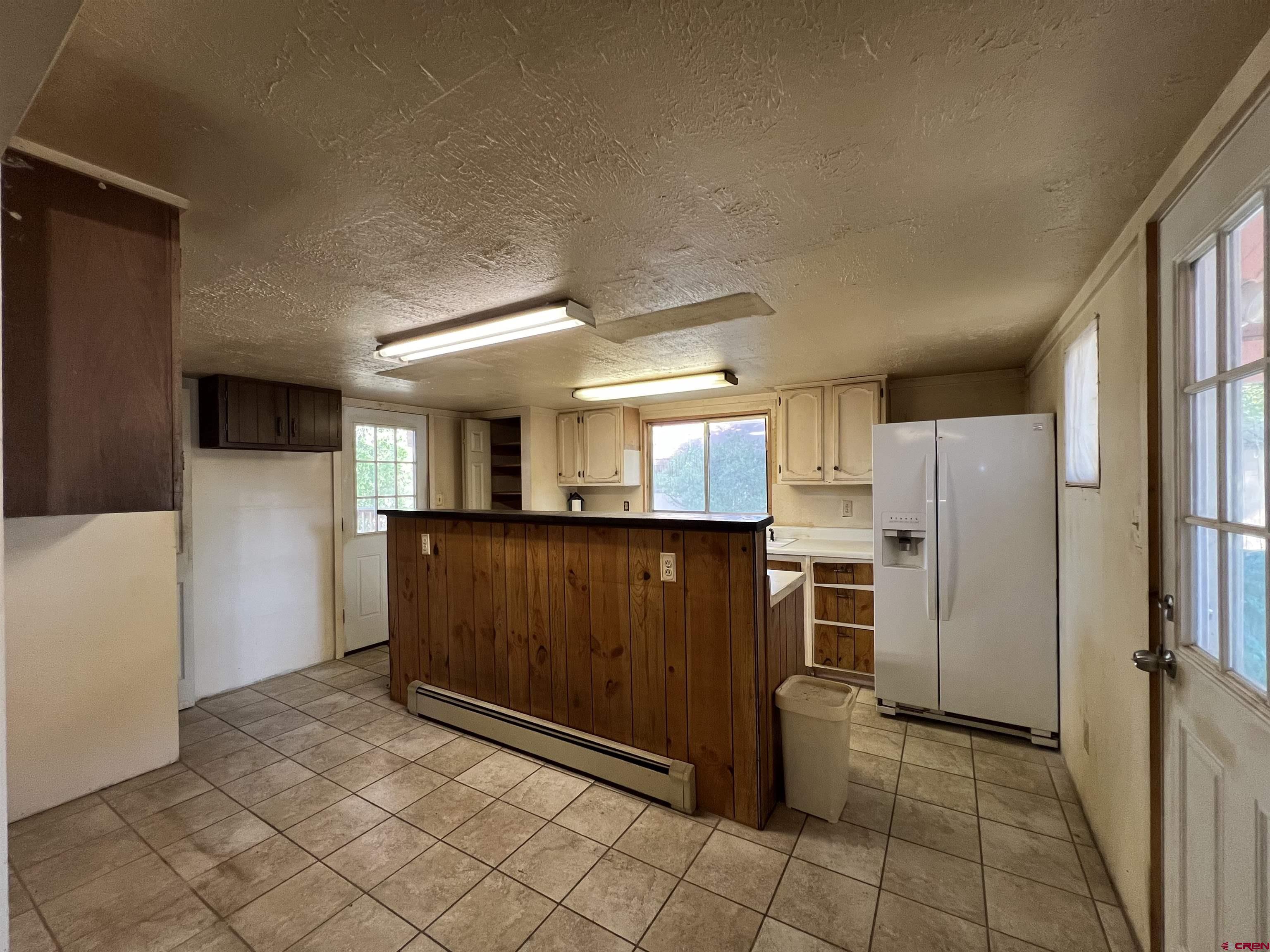 460 Fox Street Nucla, CO 81424 - Photo 24 of 35 a view of a kitchen with refrigerator and microwave
