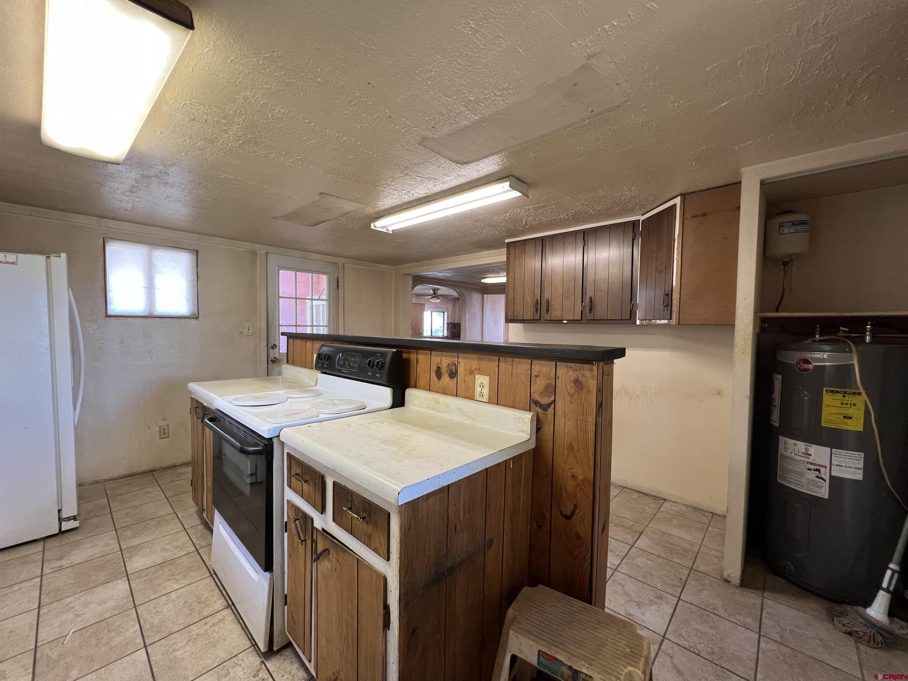460 Fox Street Nucla, CO 81424 - Photo 25 of 35 a kitchen with a sink refrigerator and microwave