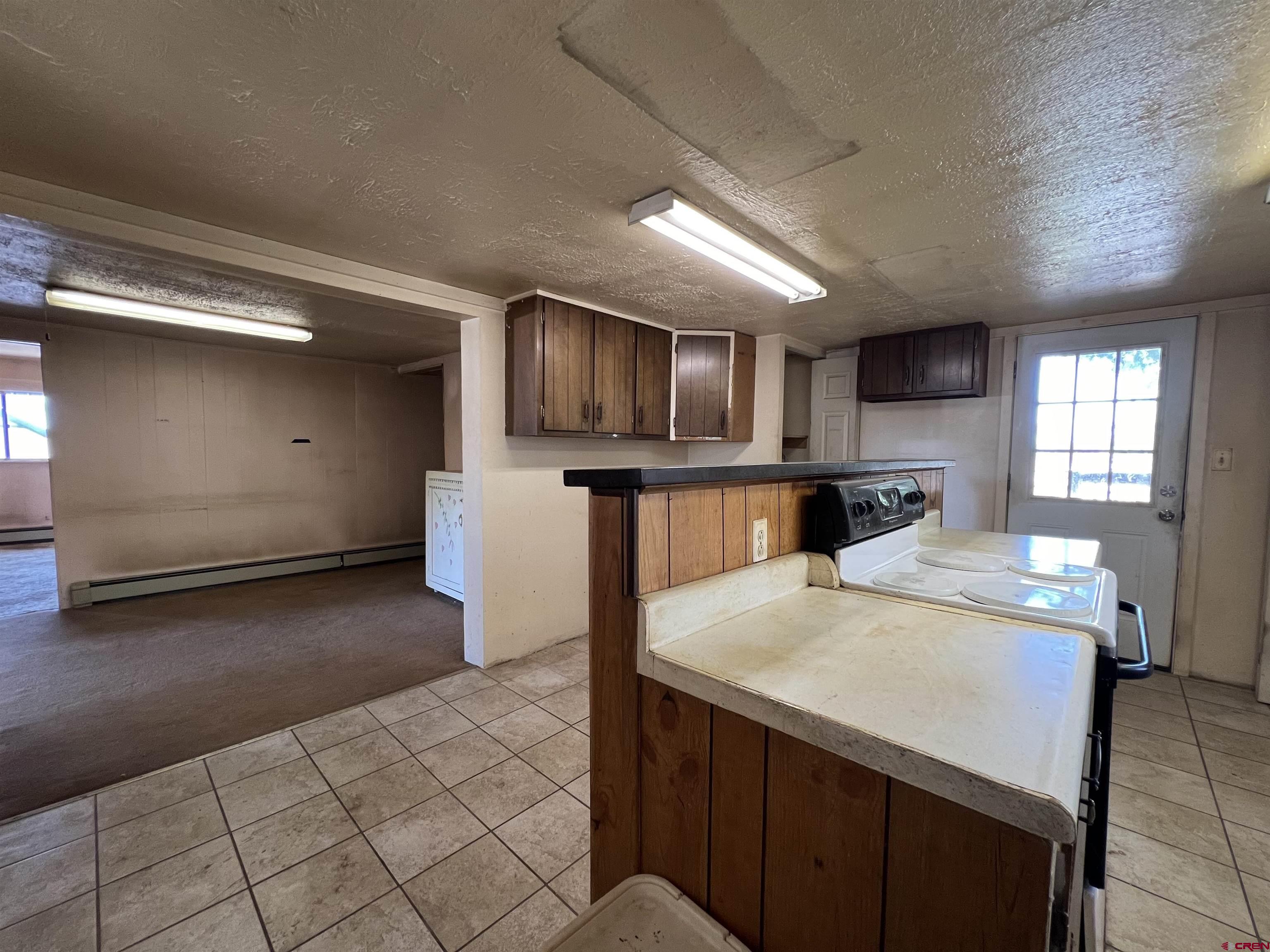 460 Fox Street Nucla, CO 81424 - Photo 27 of 35 a kitchen with stainless steel appliances a refrigerator and a stove top oven
