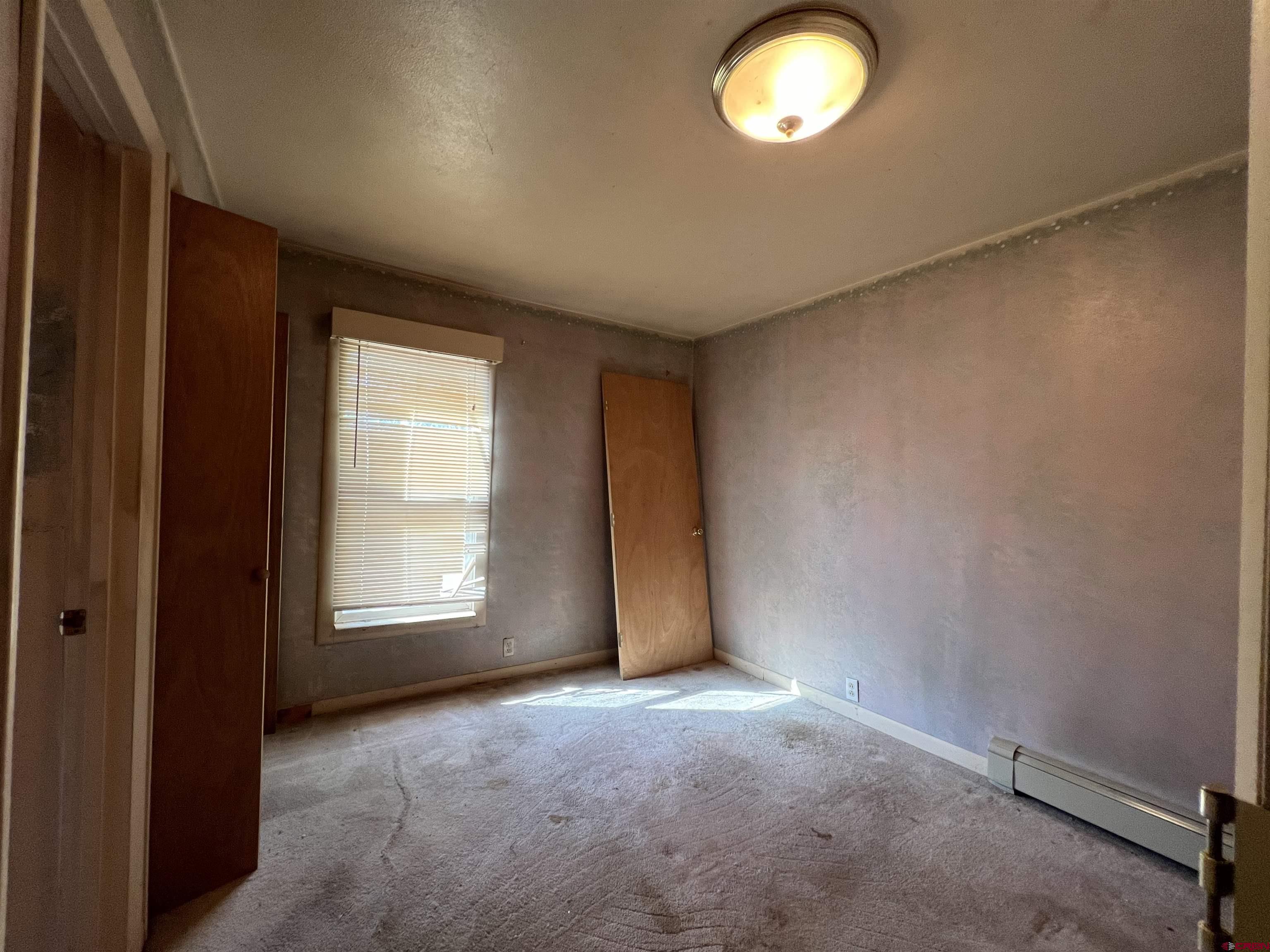 460 Fox Street Nucla, CO 81424 - Photo 32 of 35 an empty room with a window and a mirror