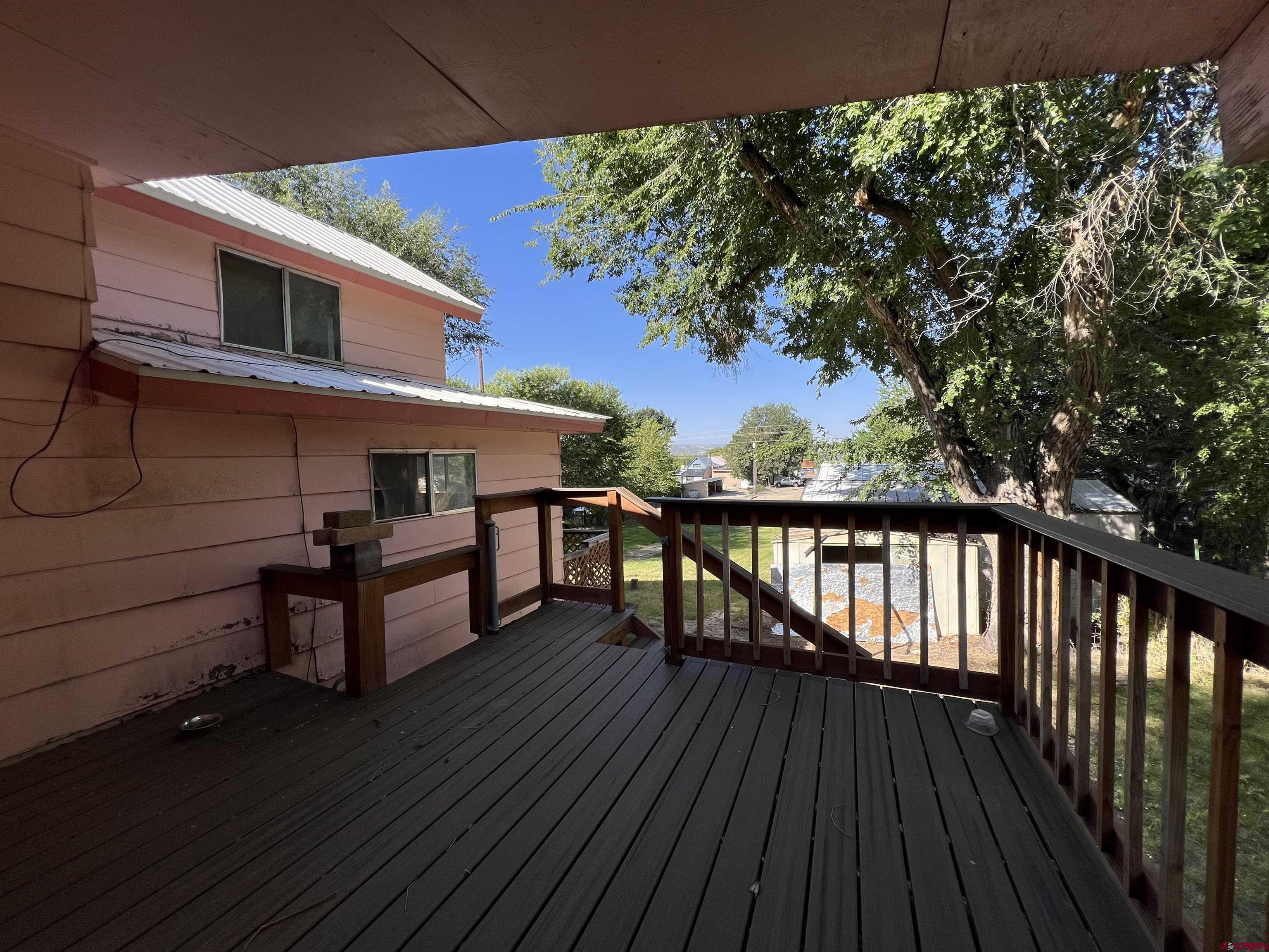 460 Fox Street Nucla, CO 81424 - Photo 8 of 35 a view of a roof deck with wooden floor and fence