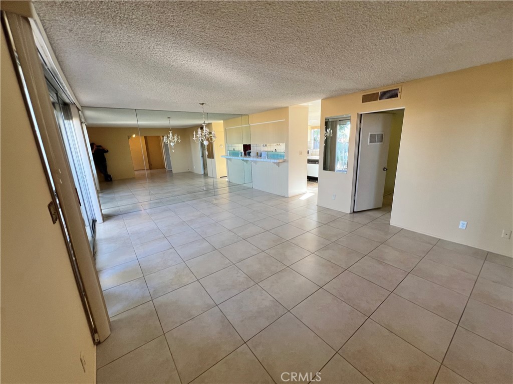 42278 Dunes View Road, Unit 28 Rancho Mirage, CA 92270 - Photo 14 of 57 a view of a hallway with wooden floor and a bathroom