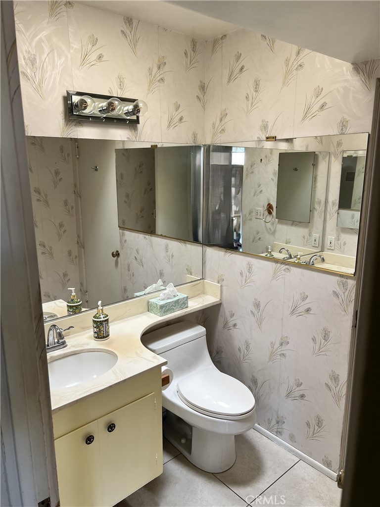 42278 Dunes View Road, Unit 28 Rancho Mirage, CA 92270 - Photo 27 of 57 a bathroom with a granite countertop toilet sink and mirror