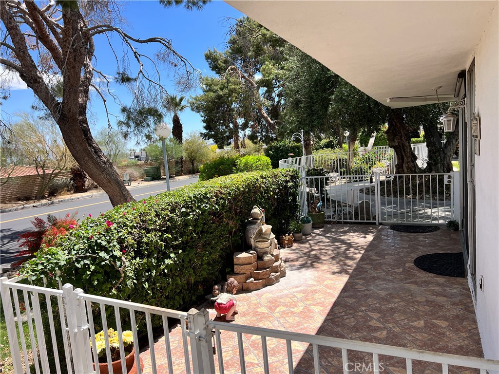 42278 Dunes View Road, Unit 28 Rancho Mirage, CA 92270 - Photo 30 of 57 a view of a patio with couches table and chairs and potted plants