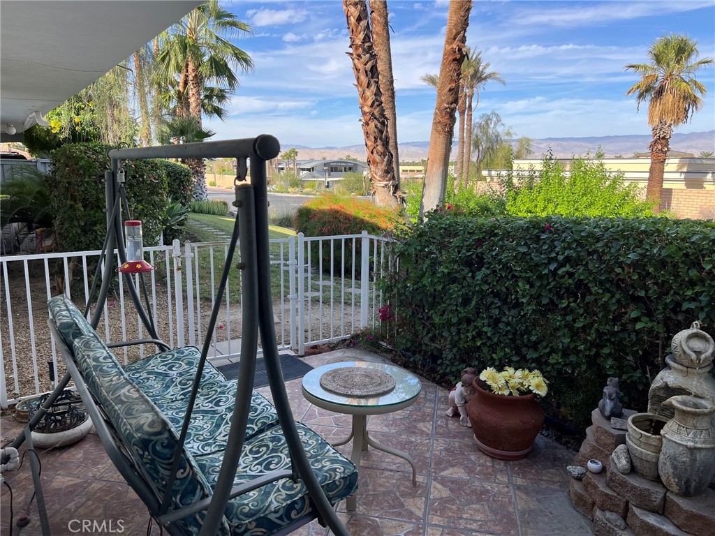42278 Dunes View Road, Unit 28 Rancho Mirage, CA 92270 - Photo 4 of 57 a view of a balcony with chair and potted plants