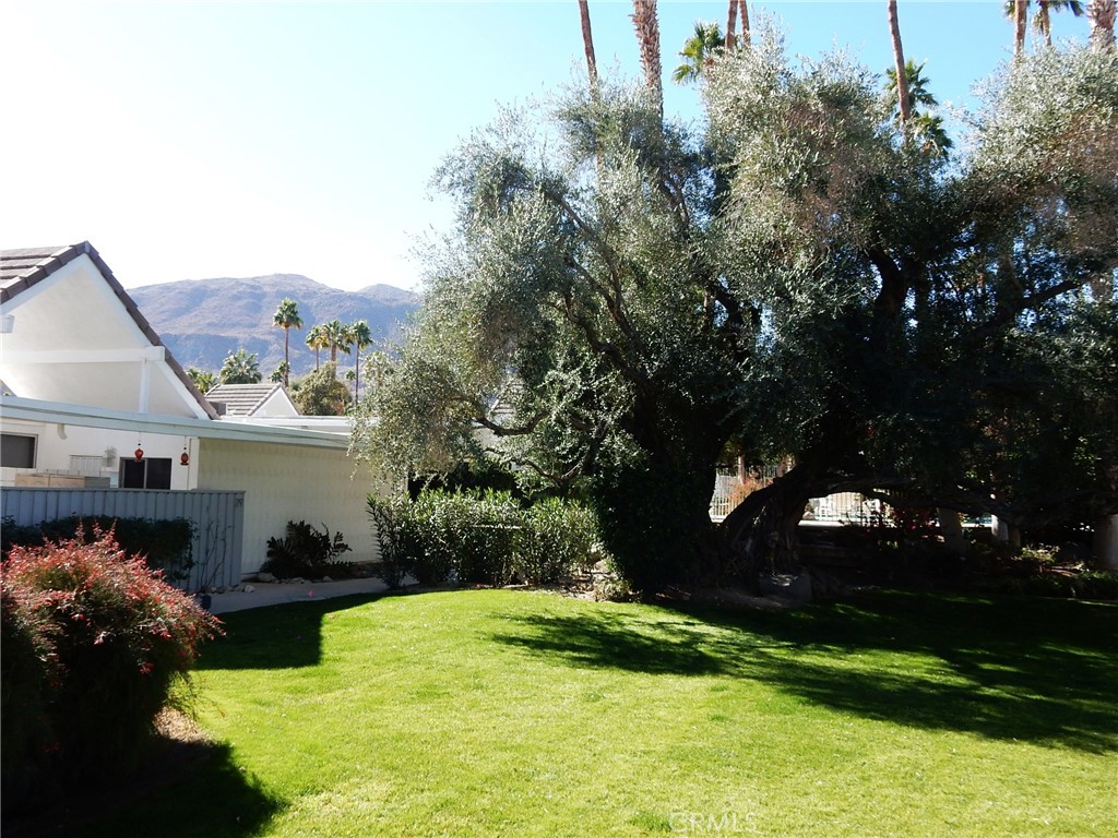 42278 Dunes View Road, Unit 28 Rancho Mirage, CA 92270 - Photo 50 of 57 a view of a house with a yard and a garden