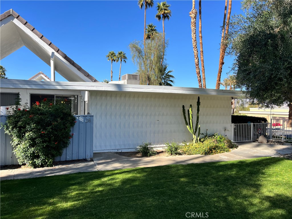 42278 Dunes View Road, Unit 28 Rancho Mirage, CA 92270 - Photo 6 of 57 a view of a backyard with table and chairs potted plants and large tree
