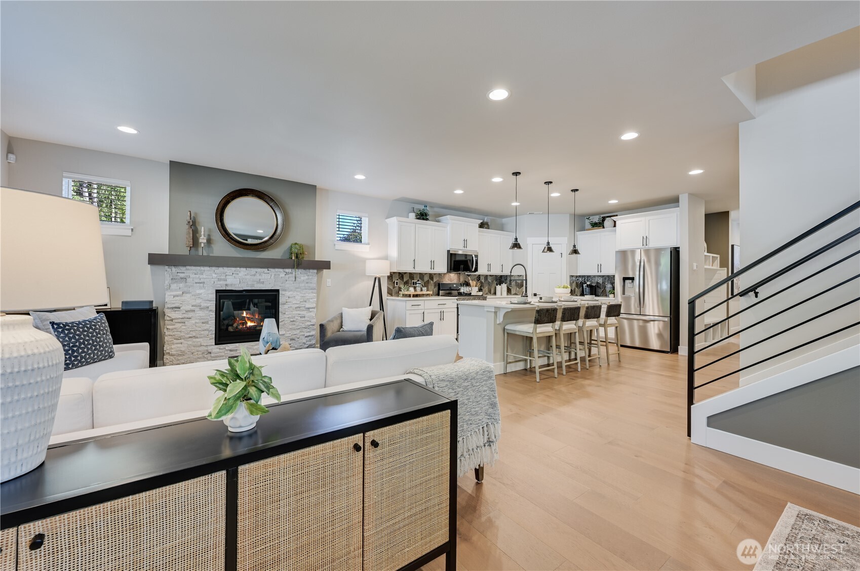 19216 Meridian Drive Southeast, Unit CW 07 Bothell, WA 98012 - Photo 17 of 37 a living room with furniture a clock and a fireplace