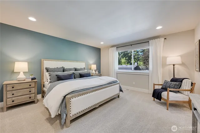 a bedroom with a bed and chair