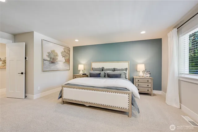 a bedroom with a large bed and a window