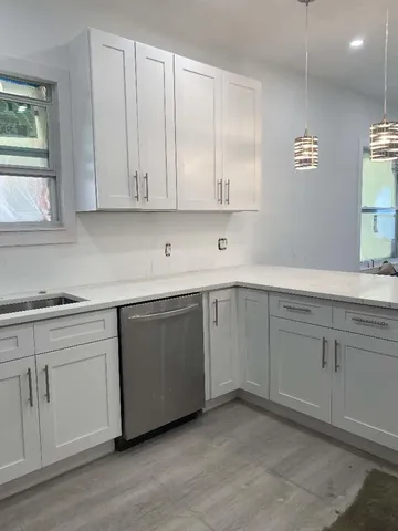 a kitchen with a sink cabinets and window