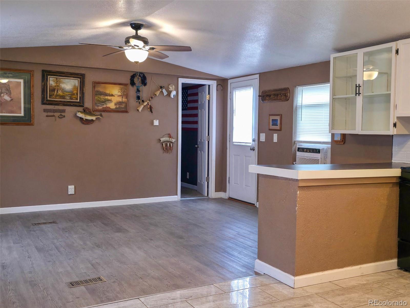 1401 9th Street Fort Lupton, CO 80621 - Photo 13 of 17 a view of kitchen with granite countertop cabinets and refrigerator