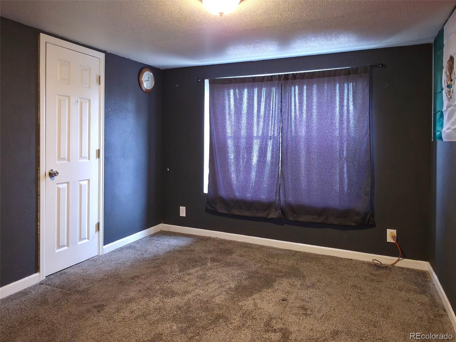1401 9th Street Fort Lupton, CO 80621 - Photo 14 of 17 an empty room with windows
