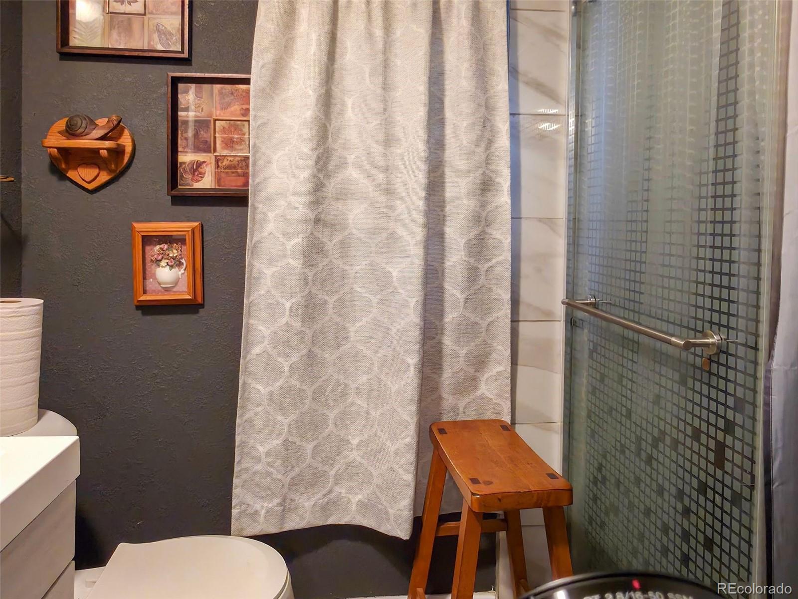 1401 9th Street Fort Lupton, CO 80621 - Photo 15 of 17 a bathroom with a toilet and a sink