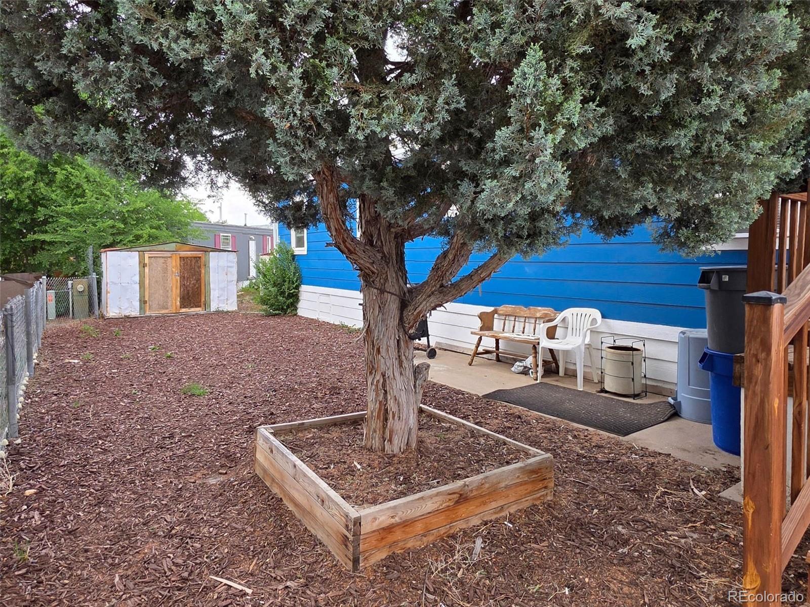 1401 9th Street Fort Lupton, CO 80621 - Photo 2 of 17 a table and chairs with wooden fence