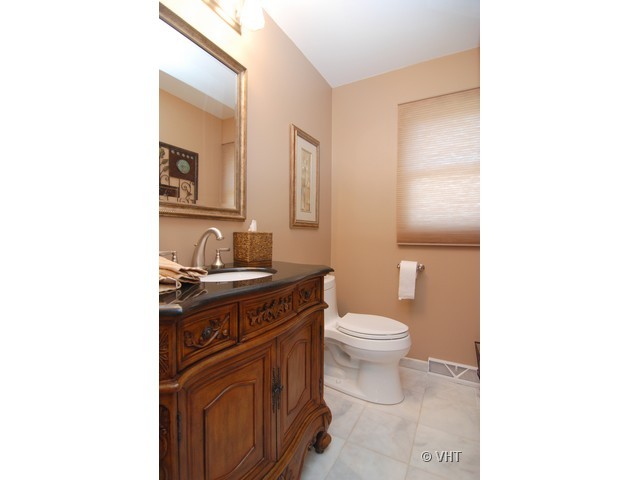 739 Sumac Road Highland Park, IL 60035 - Photo 9 of 10 a bathroom with a granite countertop toilet sink and mirror