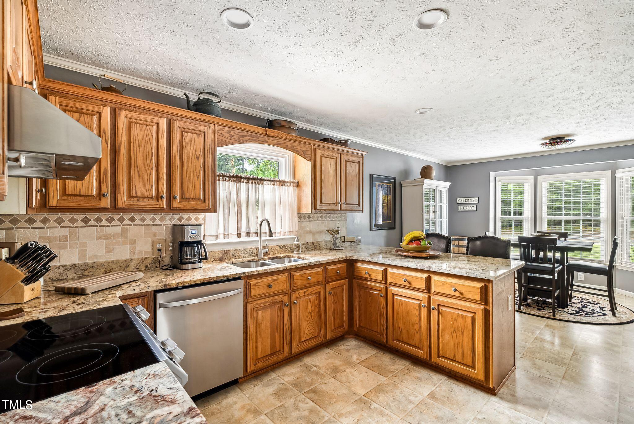 30341 East E Lake Rd Road Wagram, NC 28396 - Photo 11 of 39 a kitchen with lots of counter top space sink and stainless steel appliances