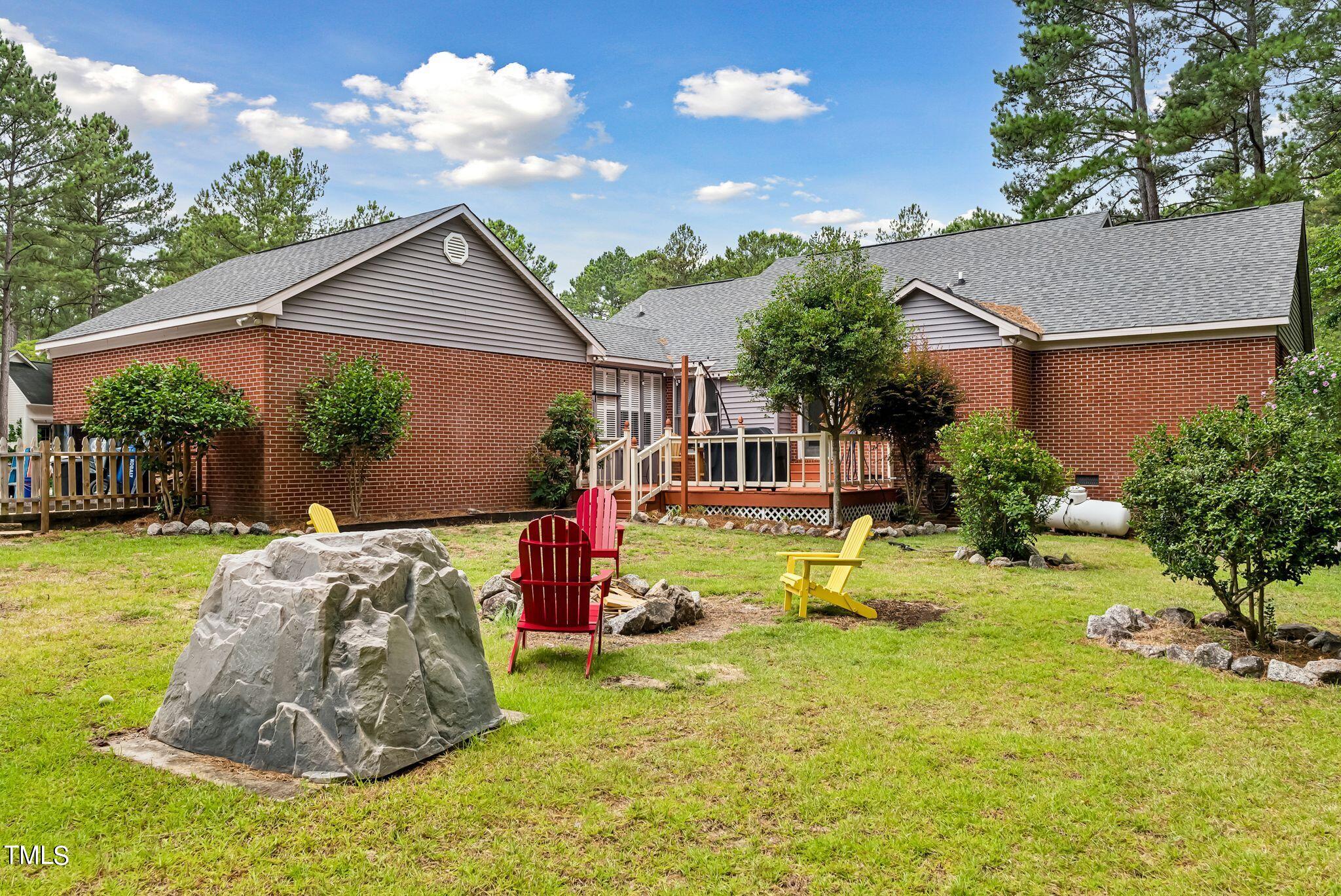30341 East E Lake Rd Road Wagram, NC 28396 - Photo 32 of 39 a view of backyard with table and chairs potted plants and large tree