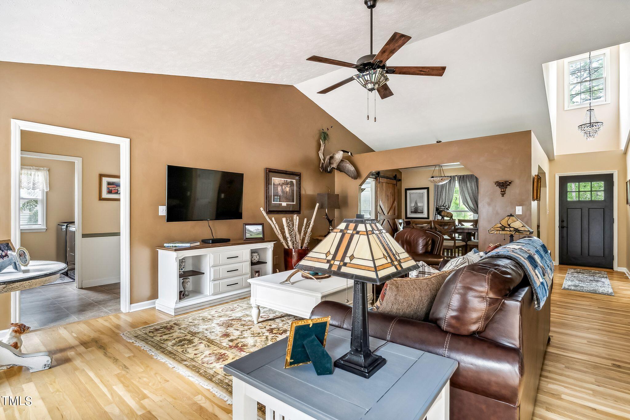 30341 East E Lake Rd Road Wagram, NC 28396 - Photo 5 of 39 a view of a livingroom with furniture a flat screen tv and a stove