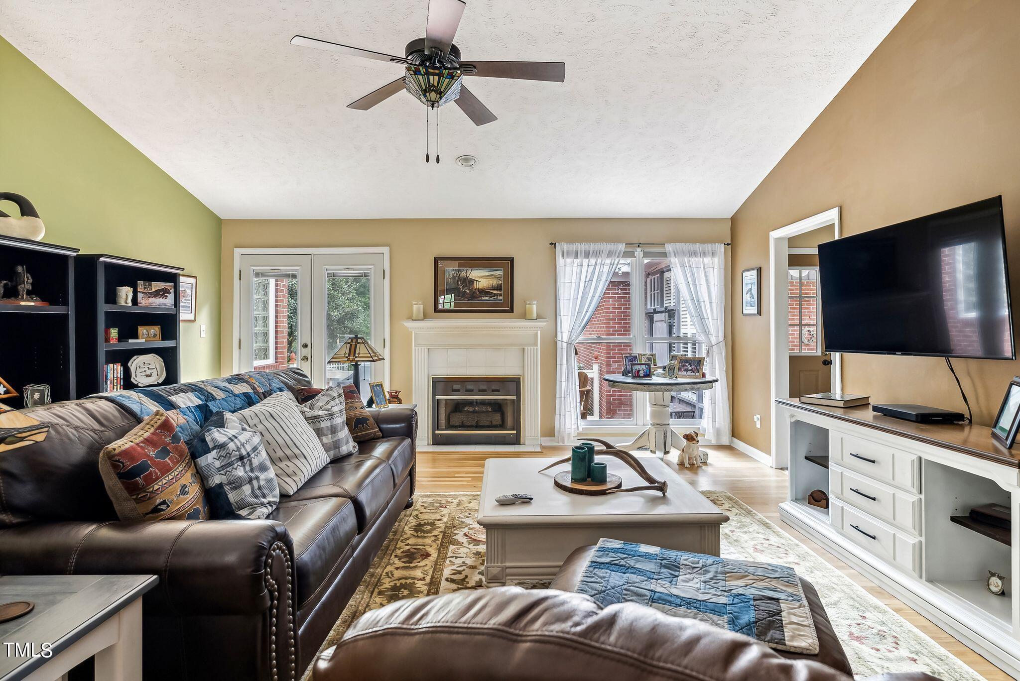 30341 East E Lake Rd Road Wagram, NC 28396 - Photo 7 of 39 a living room with furniture a flat screen tv and a fireplace