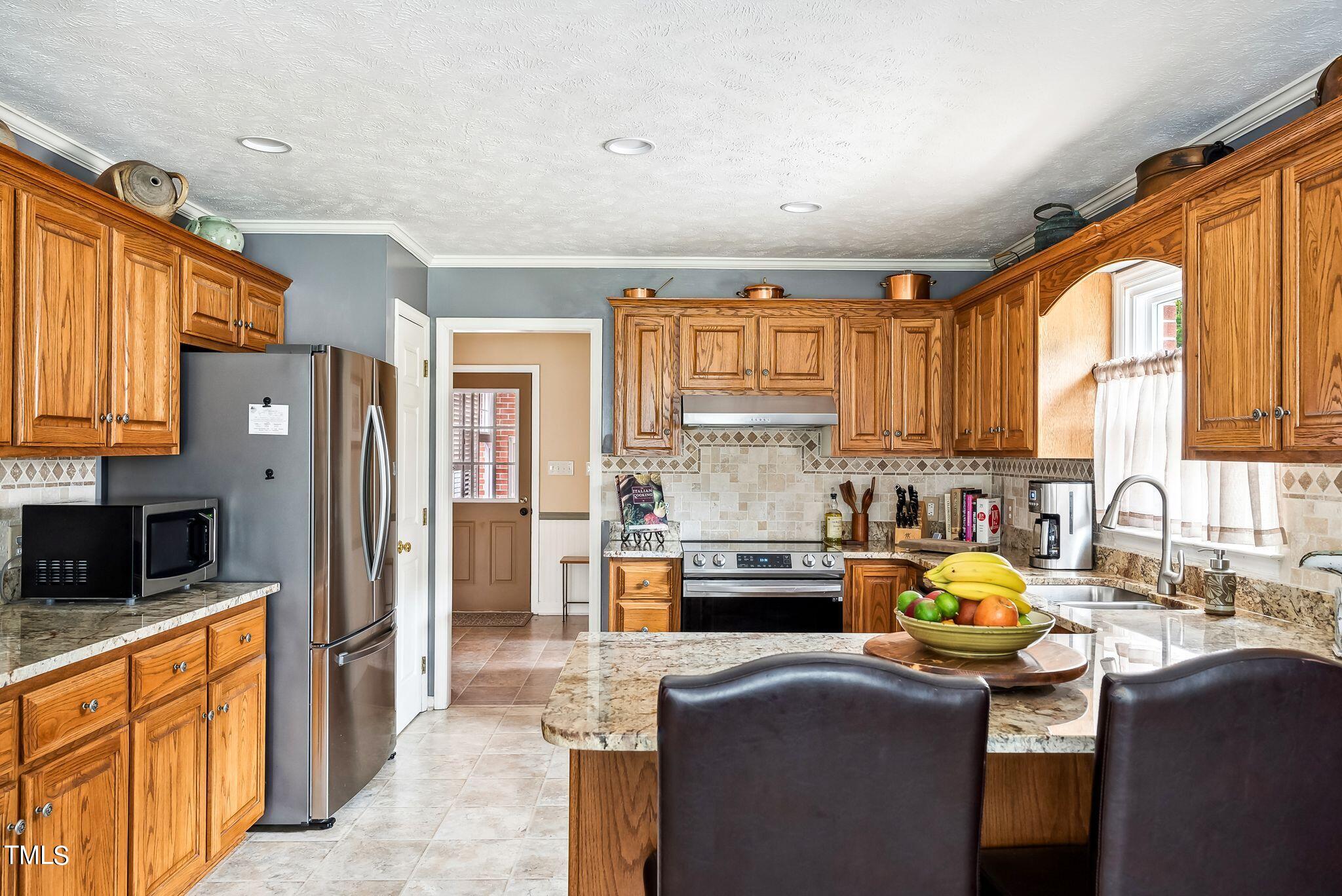 30341 East E Lake Rd Road Wagram, NC 28396 - Photo 10 of 39 a kitchen with stainless steel appliances a stove sink refrigerator and cabinets